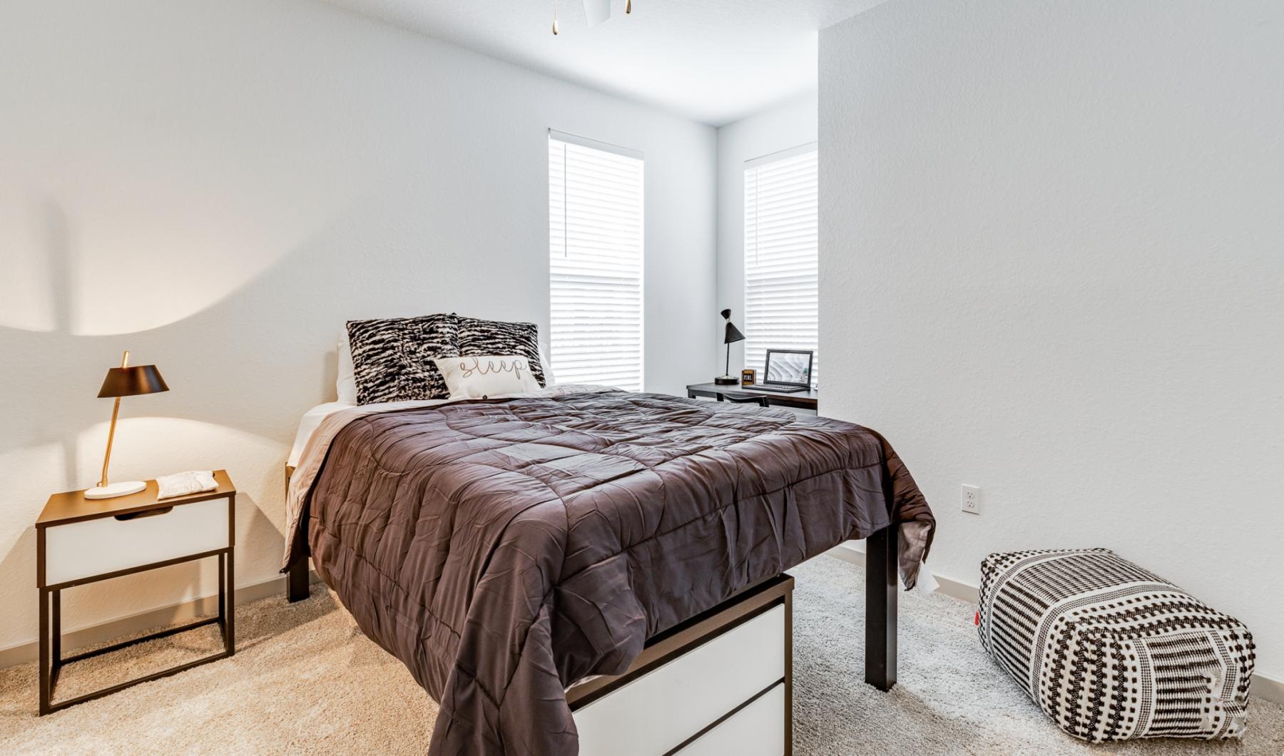 a bedroom with a bed and a fan